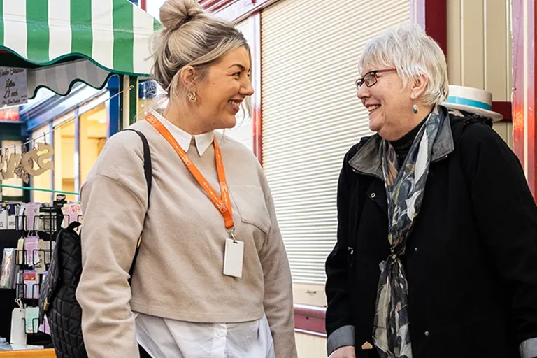 Client and Carer strolling through the local market 