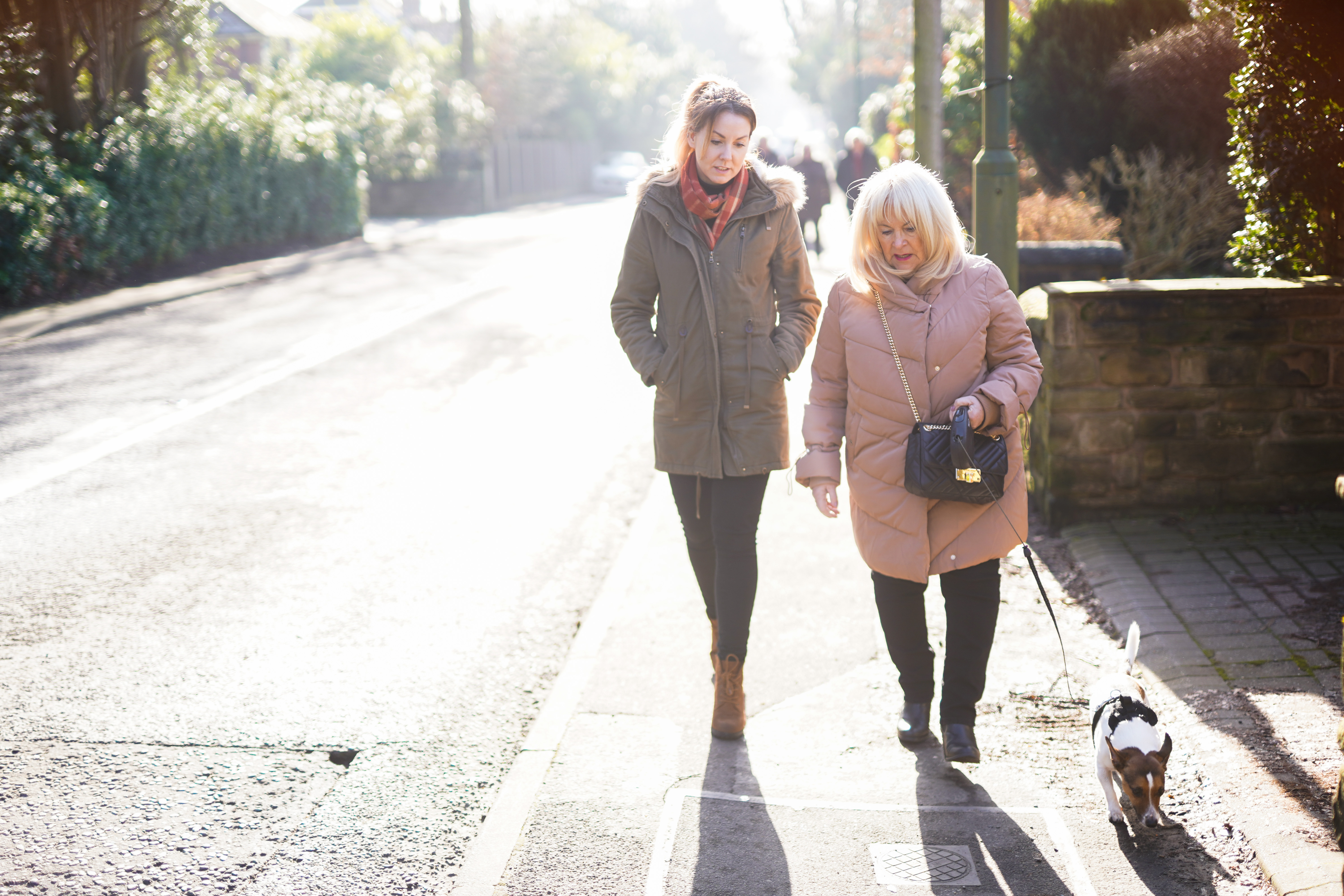 Carer walking with client down the street