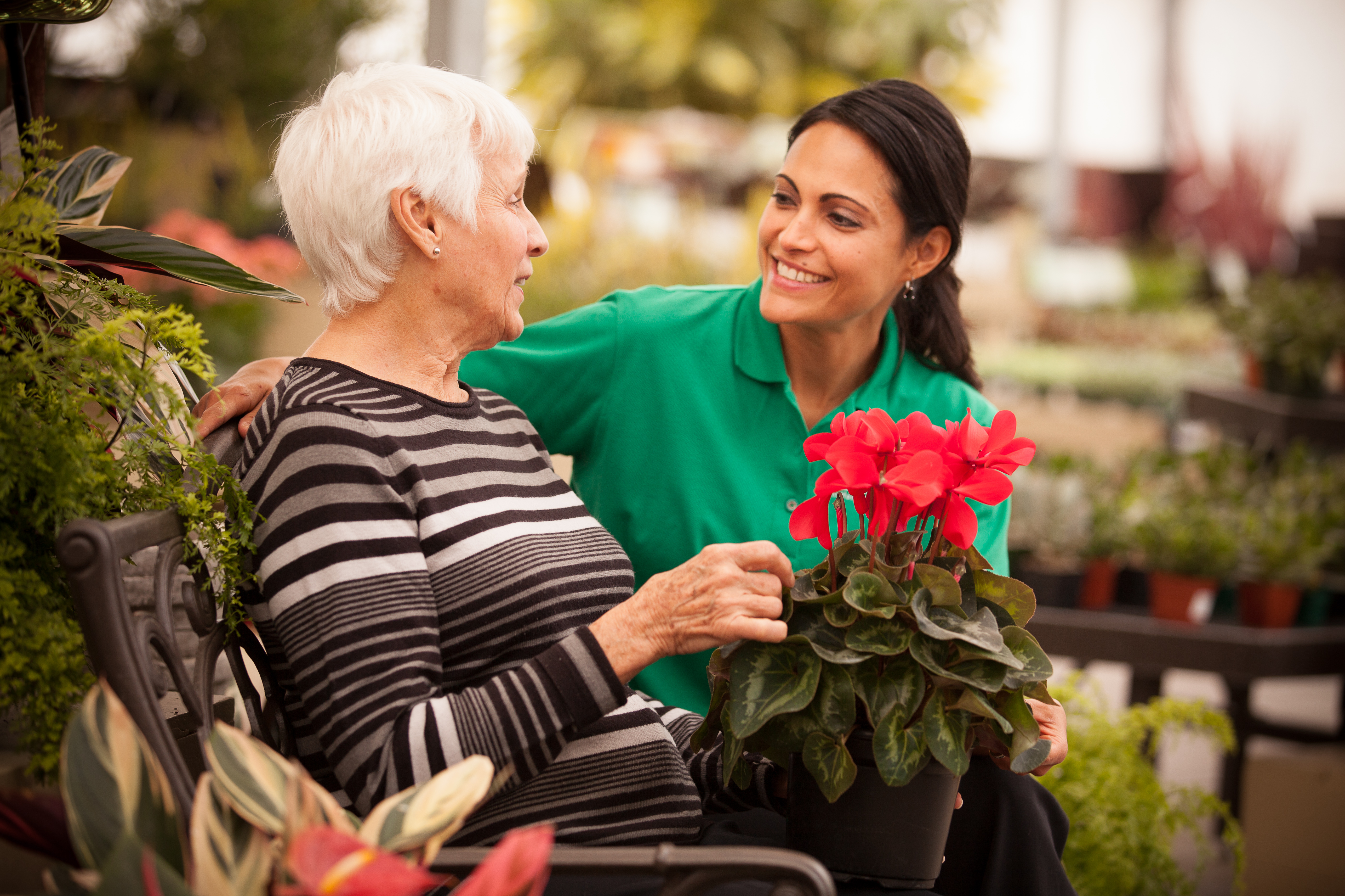Caregiver with client in garden centre
