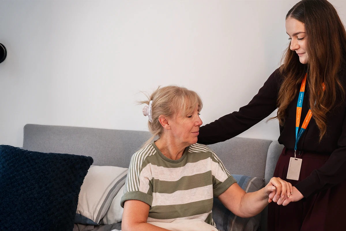 Client supported by a carer as part of their daily care routine